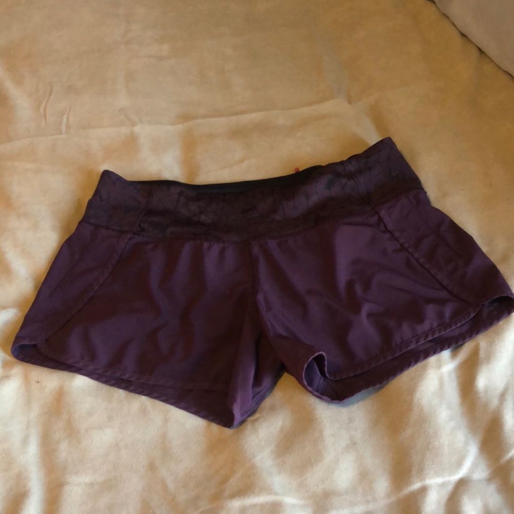 Burgundy Lululemon.  Black spiderweb design, hot pink zipper pocket.  Not lined.